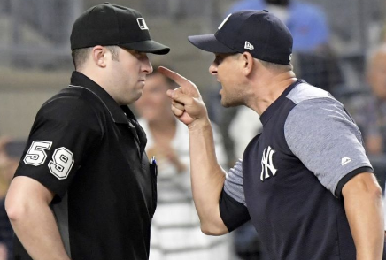 Aaron Boone, Manager of the New York Yankees, argues balls and strikes at home-plate ump, Brennan Miller.