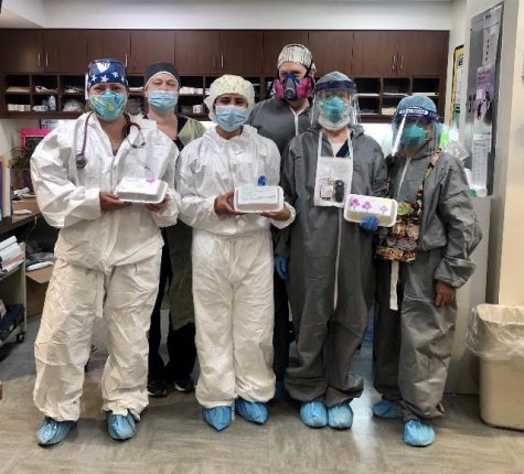 Schmalz (left) and her colleagues pose with gifts sent to them, thanking them for their work during the pandemic.