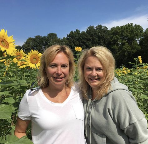 Joann Montague (right) and her sister (left) in a sunflower field.