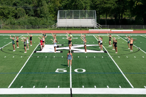 The cheerleaders working on jumps on the brand new turf field.
