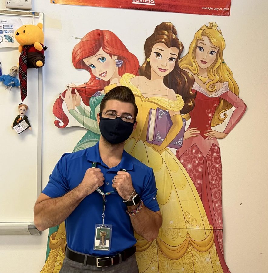 Mr.+Delpiano+poses+with+Disney+princesses+in+his+classroom.