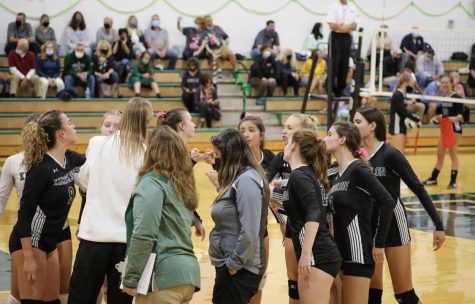 The girls volleyball team showed teamwork at a game last season.