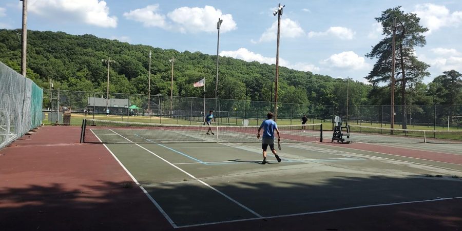 Akshat+Mittal+and+Andrew+Garcia+duel+in+a+close+one-on-one+pickleball+game+at+the+Boonton+Avenue+field.%0A