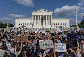 Image from AP News. Protestors gather outside of the Supreme Court during the Dobbs hearings.