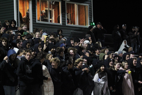 KHS students watch the football game against North Warren in the student section. The theme for the game was a blackout and many students attended.
