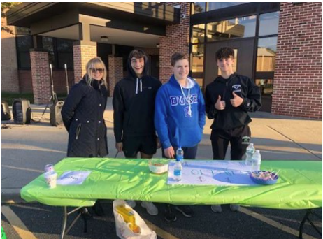 Coltfest Club includes (from left) business teacher Cathy Gilligan,  and students Parker Lazarski, Cole Pryor, and Marco Leitao) posing for a picture during the tailgate.
