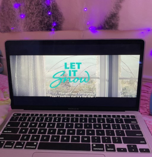 A holiday film being streamed on a laptop in bed during the winter.
