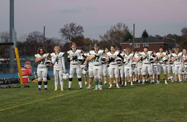 The+Kinnelon+High+School+football+team+salutes+the+flag+during+the+national+anthem%2C+as+they+play+in+the+Semifinal+round+of+the+Group+1+North+NJSIAA+tournament.