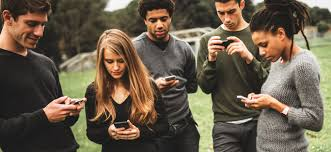 People on their phones. Photo from Newport Academy.