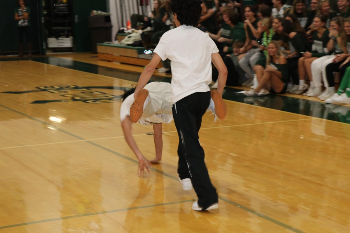 Twins Benjamin and Saul Mena race to finish the wheelbarrow relay race.
