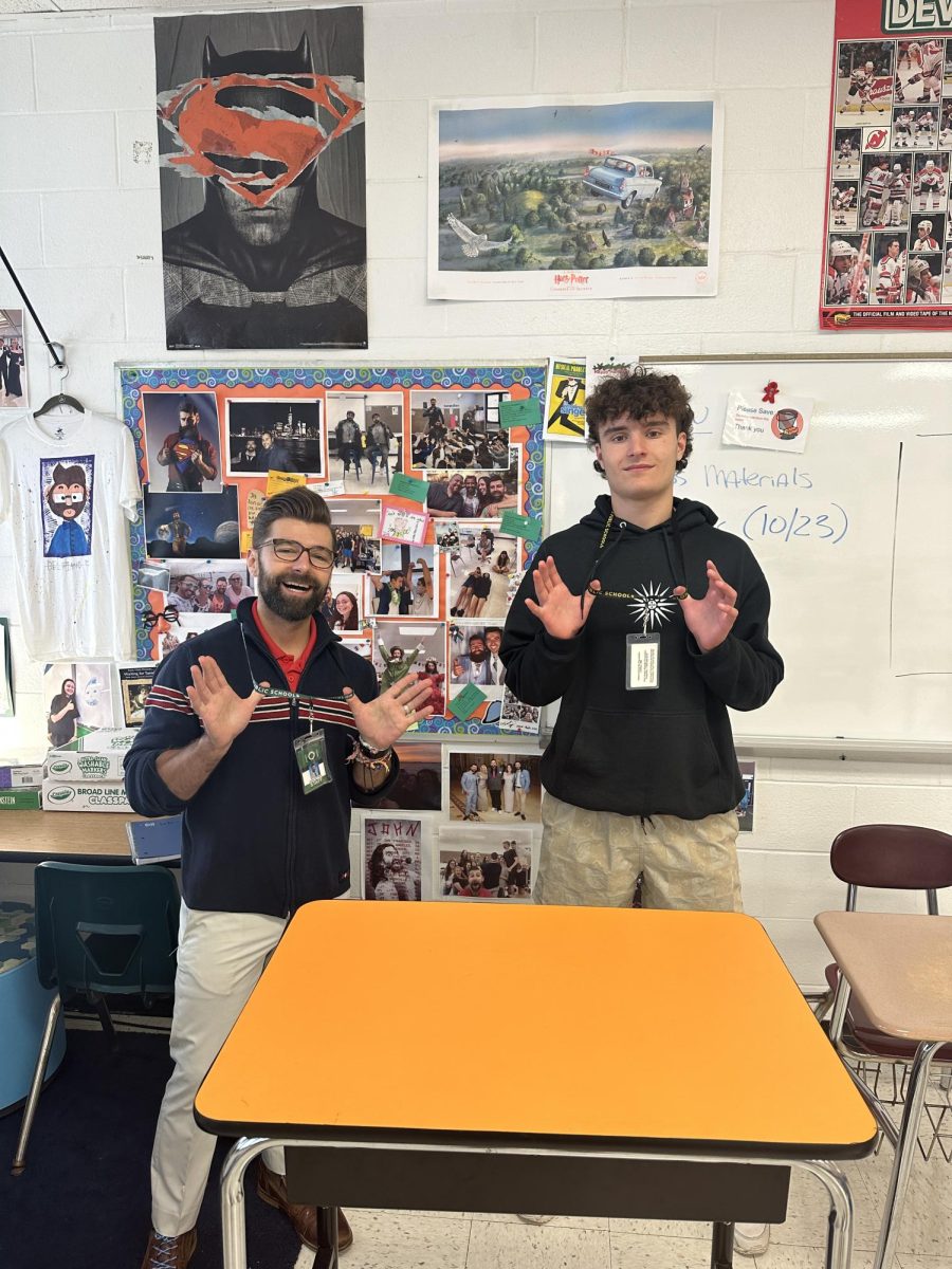 English teacher Jason DelPiano and senior Nick Maksimov correctly wearing their lanyards. 
