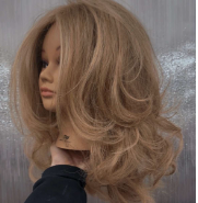 Fenelon practices and curled blows out hair on a mannequin.
