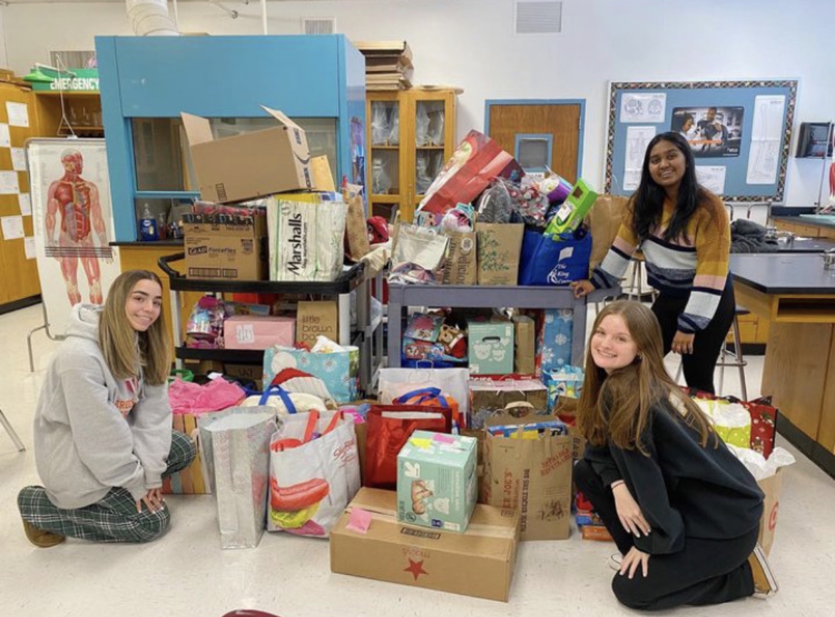 Allied Health Academy packing gifts from their holiday toy drive.