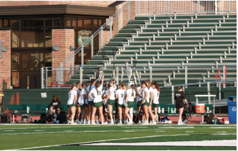 The lacrosse team huddles up before the game. 