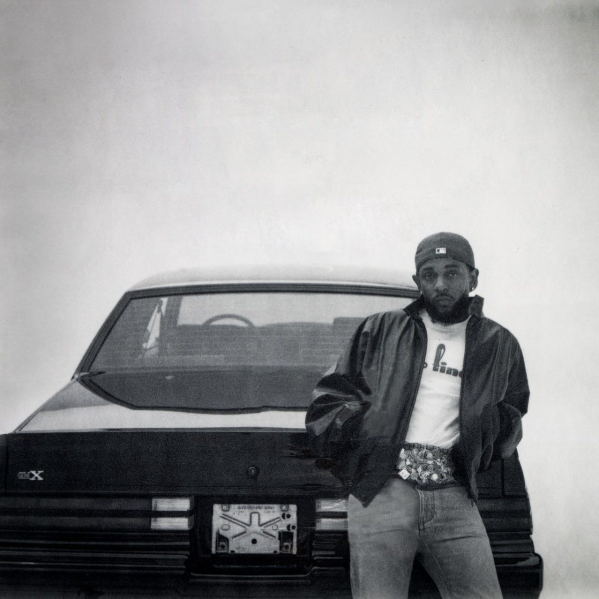 Cover art for the album, as Kendrick sits in front of the titular vehicle.