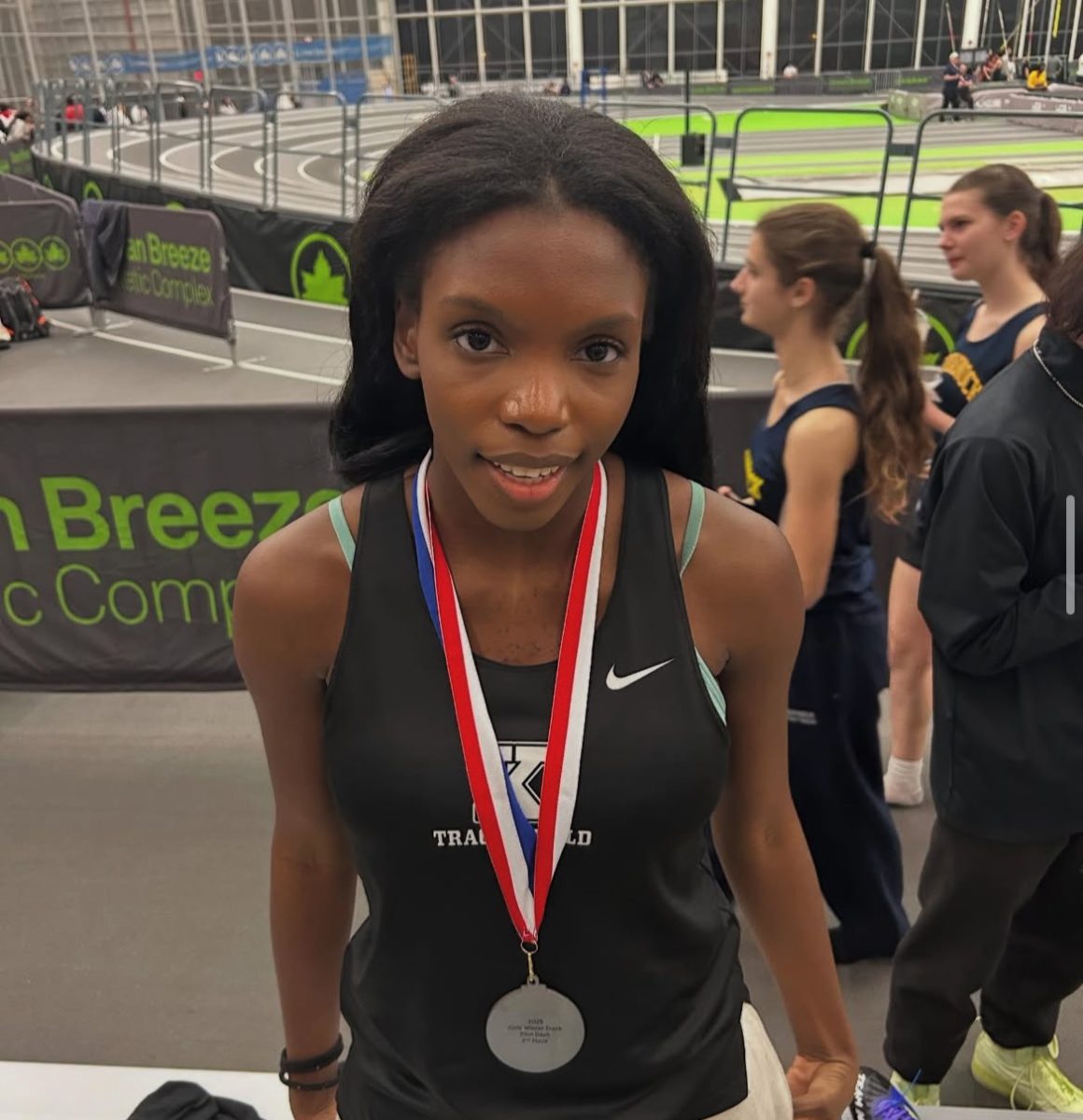 Hinton with a 2nd place medal earned by her 200 meter dash at the Ocean Breeze Complex.