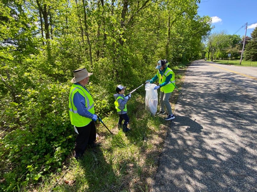 Young volunteer alongside other Kinnelon residents pick up litter.
