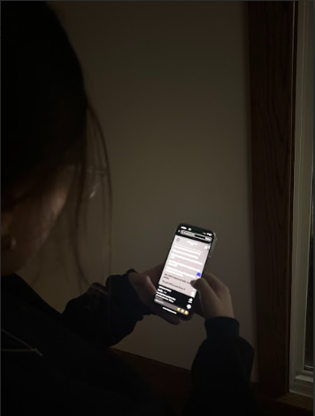 Student discovering new music on TikTok.
