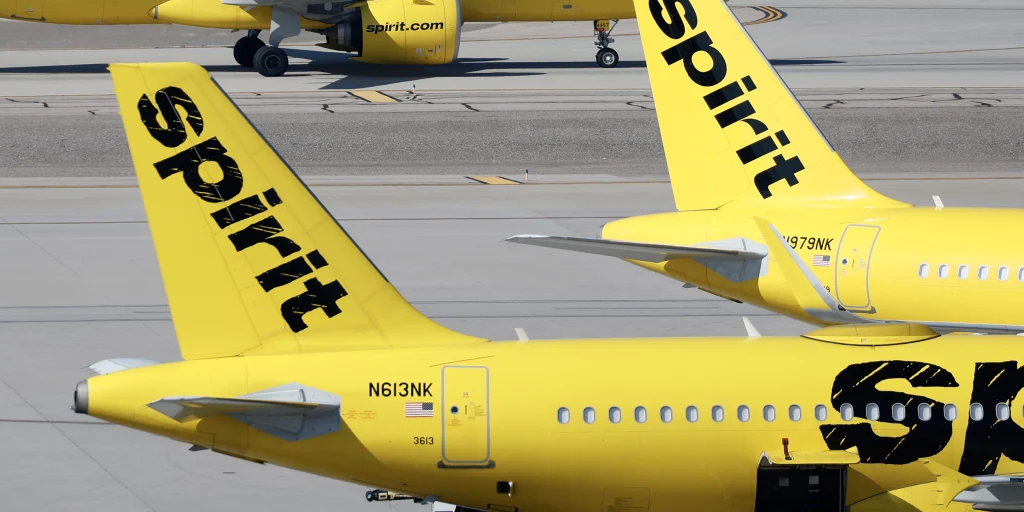 Spirit Airlines planes parked at an airport terminal.